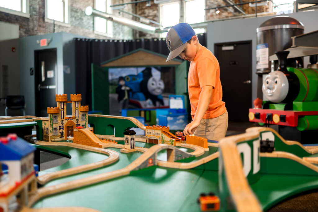 Child playing with Thomas the train engine
